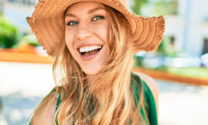 A young woman smiling in her vacation photo after teeth whitening at Green Dentistry in San Francisco.