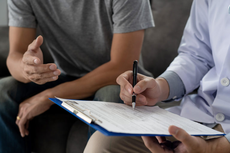 A patient consulting with a care provider for optimal health during treatment.