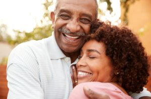 Happy couple showing their healthy smiles from deep cleaning in San Francisco.