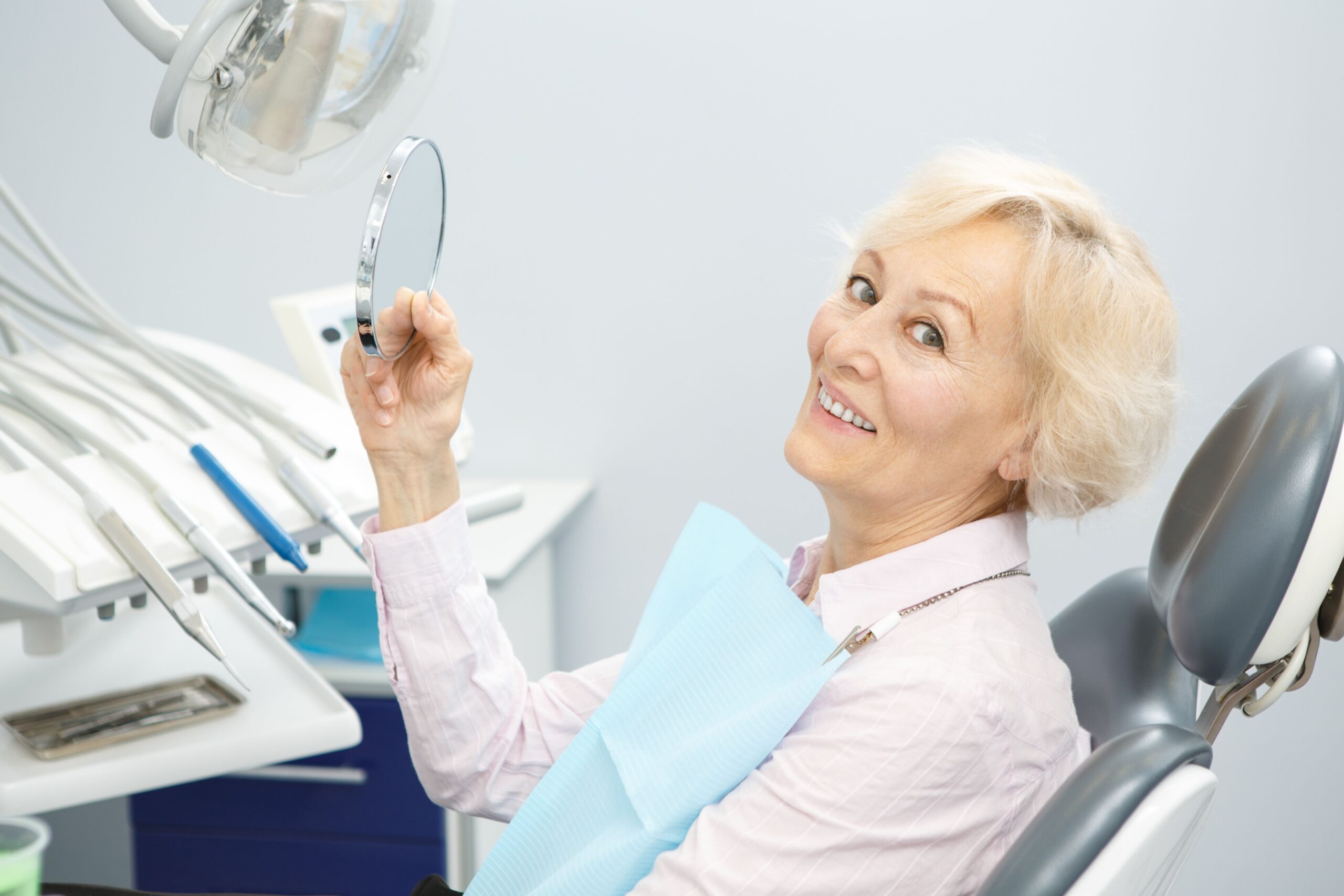 older woman smiling after laser dentistry procedure in San Francisco