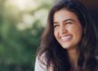 happy woman smiling outdoors, perfect teeth and gums
