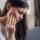 closeup of a woman suffering from jaw pain, hand on side of face