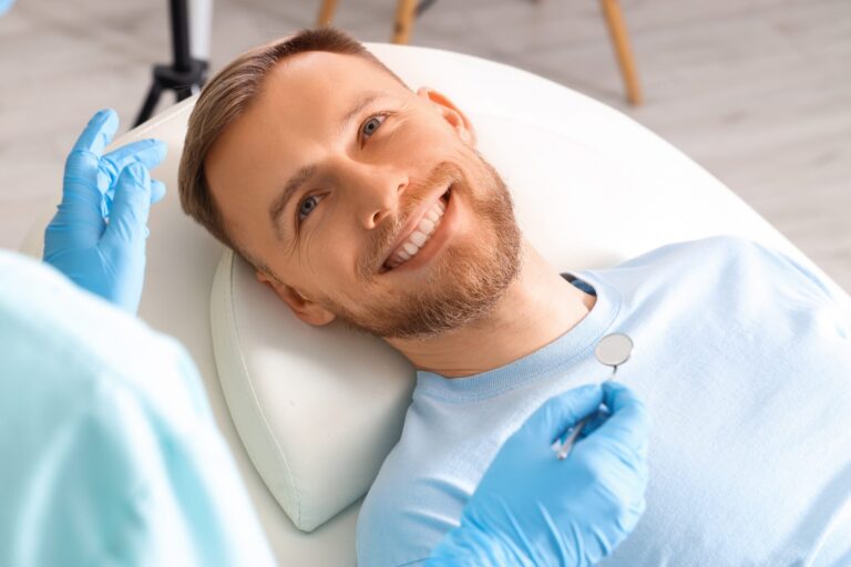 Smiling,Young,Man,Visiting,Dentist,On,Couch,In,Clinic,,Closeup closeup of a young man smiling in a dental chair
