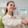 young woman smiling, shaking hands with dental assitant