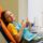 A cheerful schoolgirl gives a thumbs-up while sitting in a dental chair after a routine dentist appointment