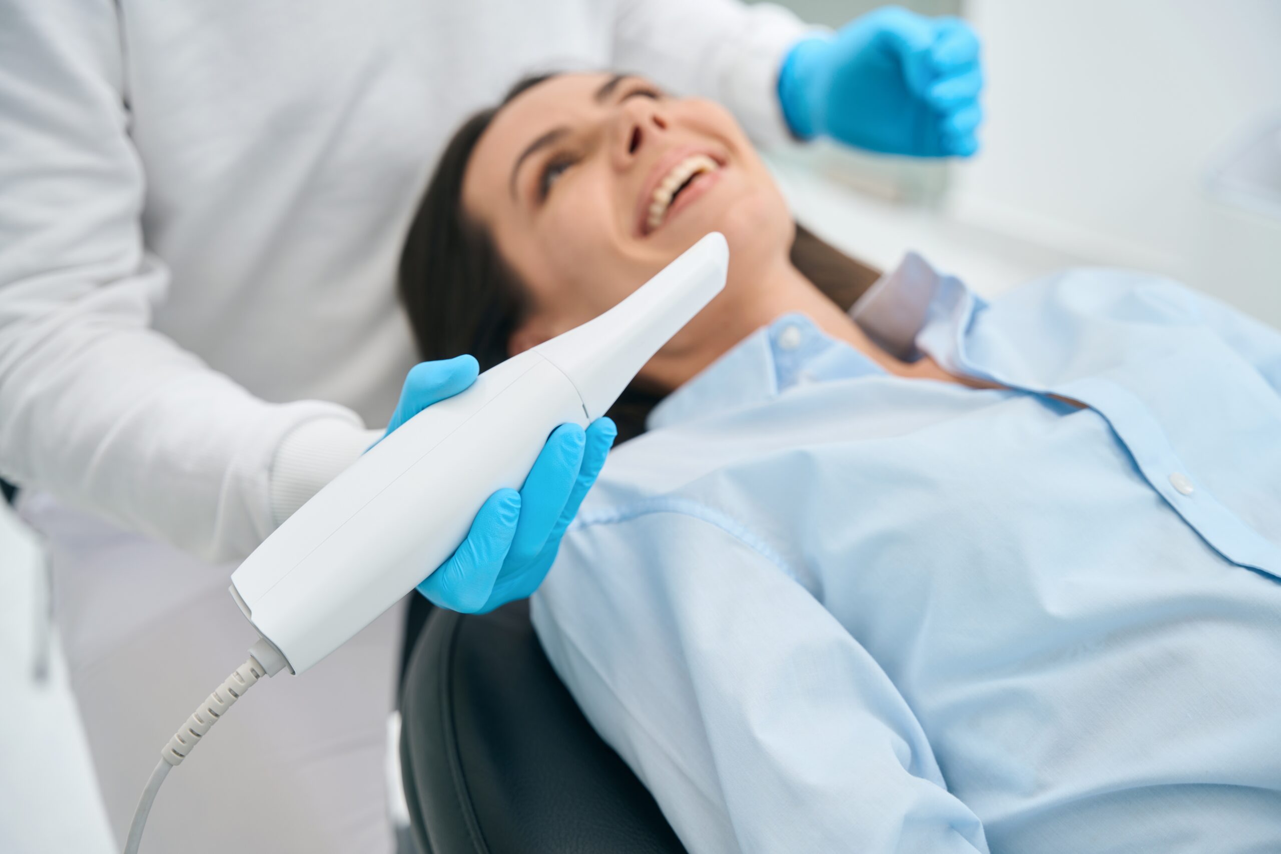 Stomatologist,In,Uniform,Taking,Intraoral,Camera,To,Examine,Mouth,Inside Dentist in uniform using an intraoral camera to examine the inside of the mouth